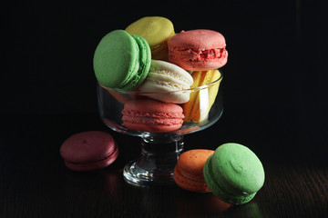 Bright macaroons against dark background	