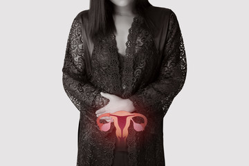 Woman in white silk nightgown and lace robe with uterus pain at night. People having belly ache. illustration of uterus is on the female body