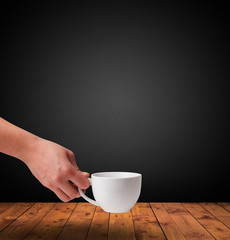 Cup of drink on wooden table with dark background
