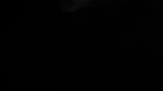 Dynamic smoke motion on a dark black background for video design