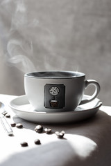 Steaming coffee cup and coffee beans