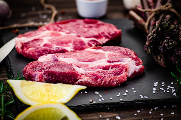 Fresh raw beef steaks on cutting board
