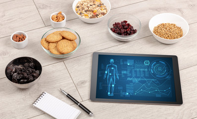 Healthy food composition with tablet. Body diagnosis on the screen