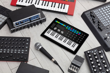 Piano synthesizer app on tablet and musical instrument concept
