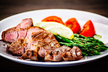 Grilled steak with asparagus on white background