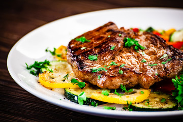 Grilled steak with potatoes and vegetable salad