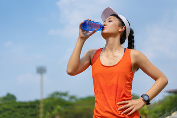 Woman runners are drinking water. After training