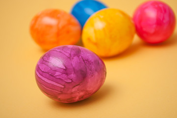 closeup of decorative painted easter eggs on yellow background