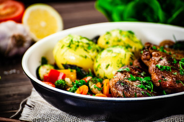 Grilled steak, boiled potatoes and vegetables