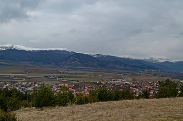 Eastern part of the Zlatitsa Pirdop valley and residential district of  village Chavdar in background of the snowy Balkan mountain, Sofia, Bulgaria, Europe 
