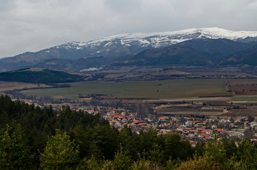 Part of the Zlatitsa Pirdop valley and residential district of  village Chavdar close in background of the snowy Balkan mountain, Sofia, Bulgaria, Europe  