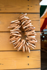 string of bagels with poppy hanging on a rural market