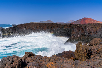 Fototapeta na wymiar Spain, Lanzarote, Breathtaking loud breaking waves in tourist attraction los hervideros bay