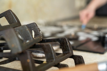 cleaning the hob, cleans with a cleanser and brush. focus on cast iron supports