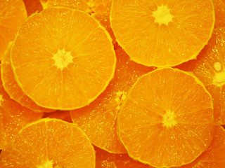 Peeled orange slices, orange background