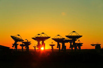 Naklejka premium Observatory equipment, silhouette at sunrise
