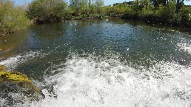 Water flowing on a small waterfall on a river, La Muga, Girona, Alt Emporda, Catalonia, Spain