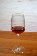 Cocktail Kir (dry white wine with blackcurrant liqueur) in a glass for red wine