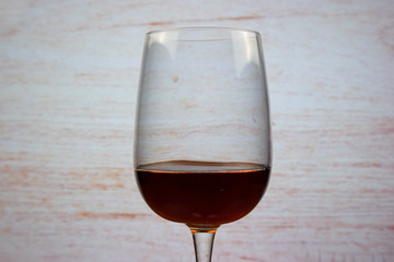 Cocktail Kir (dry white wine with blackcurrant liqueur) in a glass for red wine