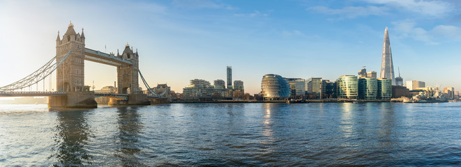 The iconic urban skyline of London, UK, during a sunny morning: from the Tower Bridge to London Bridge - obrazy, fototapety, plakaty