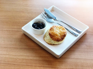 Scones,Scones with berry jam  on the wooden table natural light