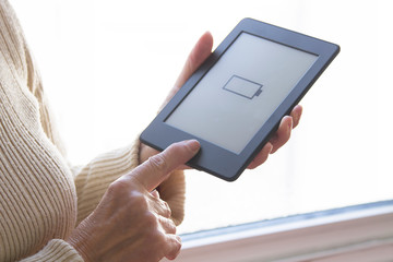 senior woman at home with digital tablet or laptop