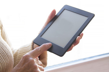 senior woman at home with digital tablet or laptop