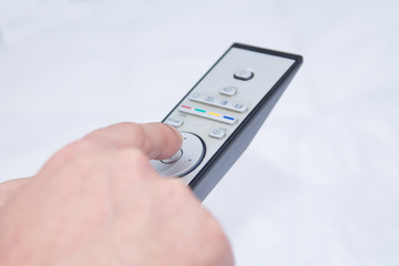 closeup adult man with tv remote control