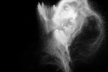 White powder explosion.Freeze motion of white dust particles on black background.