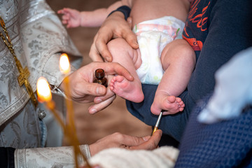 baptism of a child in the Church, the process of anointing