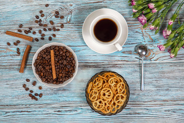 Coffee in a Cup and beans on a blue background