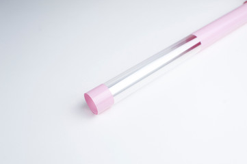 Wrapping roll of pink florist's film for packing flowers, bouquets on a white background