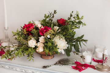 Beautiful bouquet of white and red fresh flowers standing in vase indoors. Horizontal color photography.