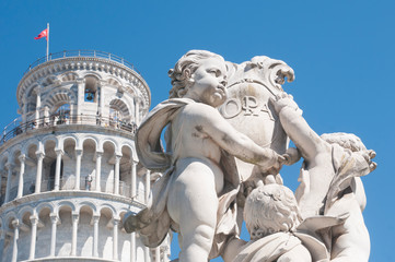 Fototapeta na wymiar Pisa: the Putti fountain and the leaning tower