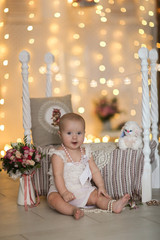 Baby girl and retro wood bed flowers and pillow