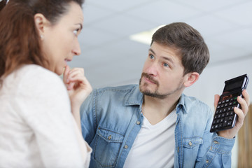upset man showing calculator