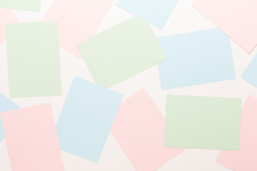 Abstract geometric background in light pastel tones from sheets of thick pale past paper.