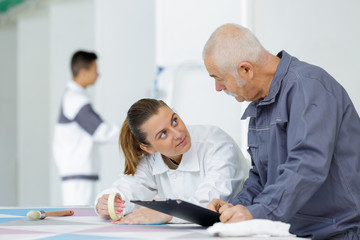 female painter in training using masking tape