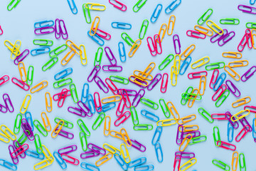Paper color clip notebook on blue background. Flat lay.