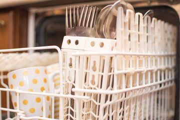 Open dishwasher with clean dishes.