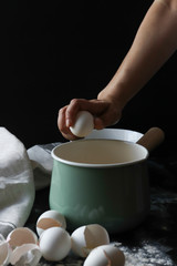 Cracking egg by hands