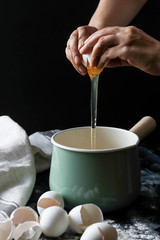 Cracking egg by hands