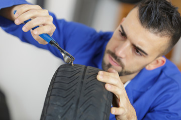 mechanic working on a tyre at workshop