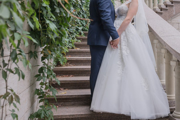 Obraz na płótnie Canvas bride and groom together on the stairs