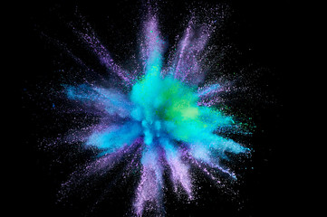 Colored powder explosion. Abstract closeup dust on backdrop. Colorful explode. Paint holi