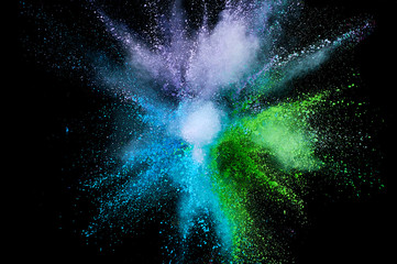 Colored powder explosion. Abstract closeup dust on backdrop. Colorful explode. Paint holi