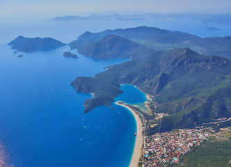 Amazing aerial view of Blue Lagoon in Oludeniz, Turkey. Summer landscape with sea spit, green trees, azure water, sandy beach in bright sunny day.