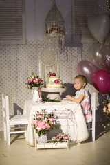 child tastes cake decorated with lively flowers