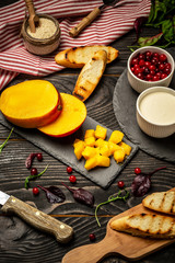 Cooking Bruschettas with cheese, Alphonso mango. Bruschetta with mango and cheese. Homemade. Healthy vegetarian nutritionon a wooden background, Top view