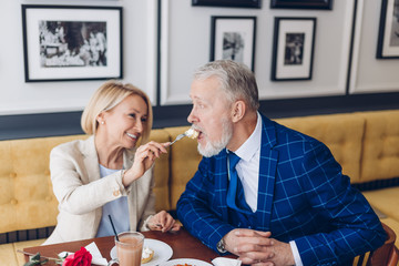 lovely couple enjoying meal in the cafe. close up photo. happy old age